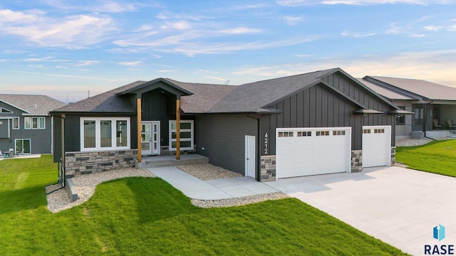 view of front facade with a lawn and a garage