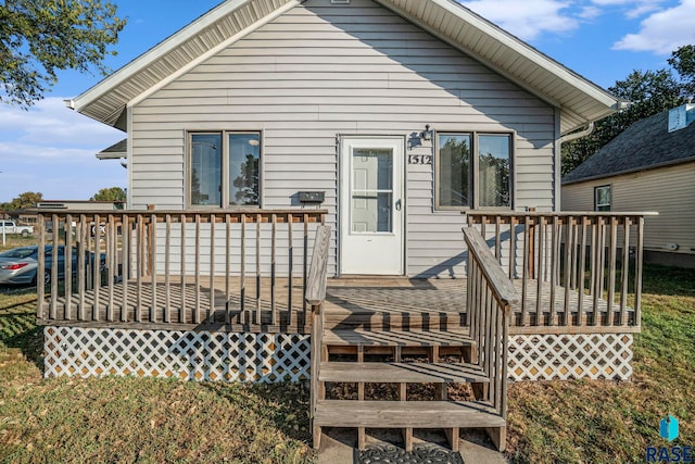 rear view of house featuring a deck