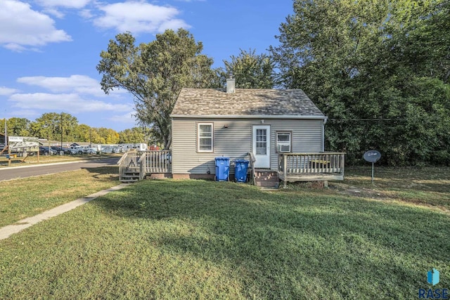 1512 W 7th St, Sioux Falls, SD 57104 - rear view of property featuring a yard, a wooden deck, a chimney, and a shingled roof