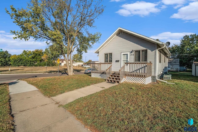 view of front of house with a front lawn and a deck