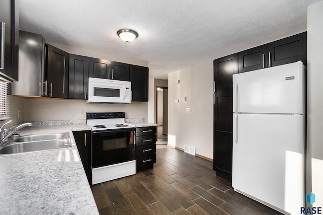 1512 W 7th St, Sioux Falls, SD 57104 - kitchen featuring white appliances, visible vents, light countertops, a sink, and wood tiled floor