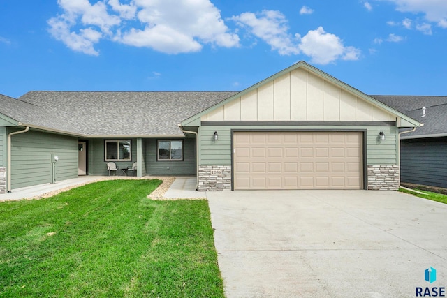 ranch-style home with a front yard and a garage