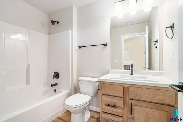 full bathroom with tub / shower combination, hardwood / wood-style flooring, vanity, and toilet