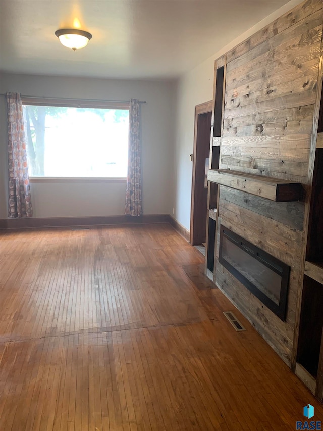 unfurnished living room with dark hardwood / wood-style floors