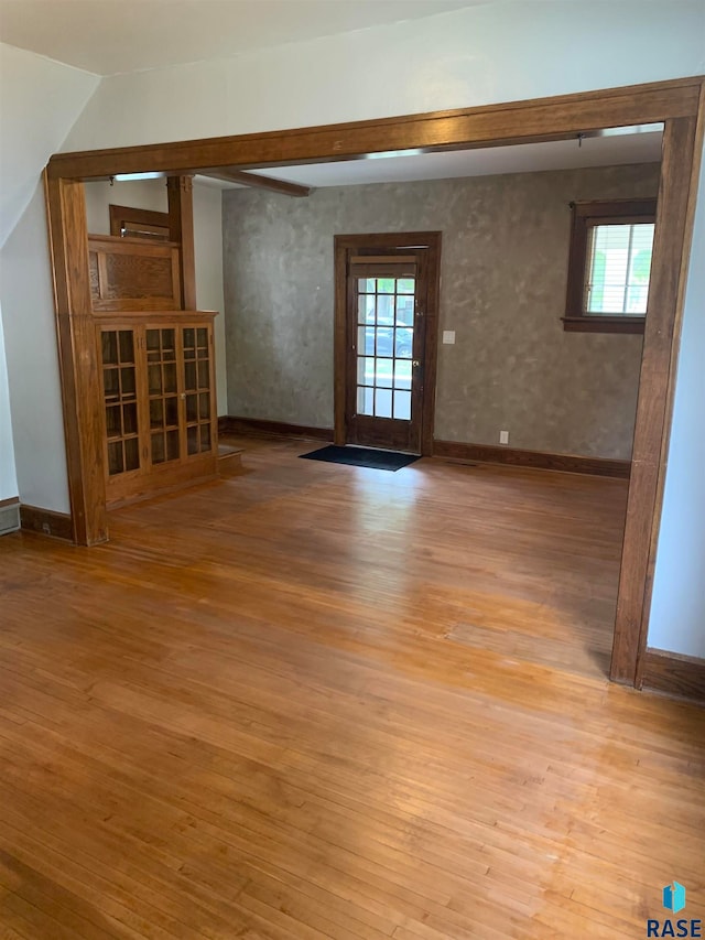 spare room with light hardwood / wood-style floors and plenty of natural light