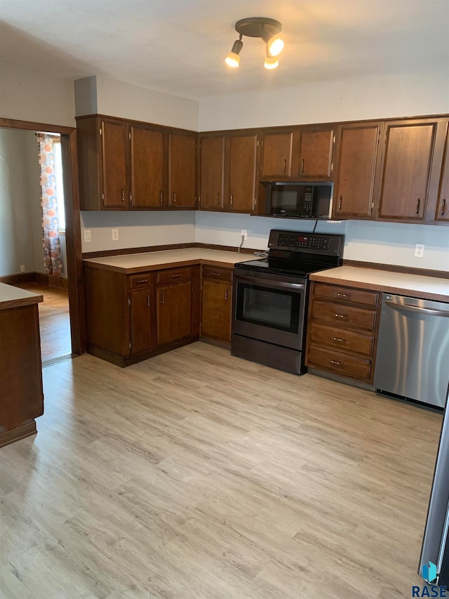 kitchen featuring stainless steel appliances and light hardwood / wood-style floors