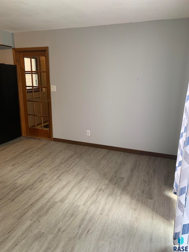 spare room featuring light wood-type flooring