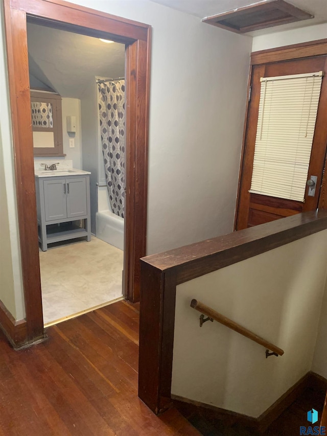 corridor featuring dark hardwood / wood-style flooring and sink