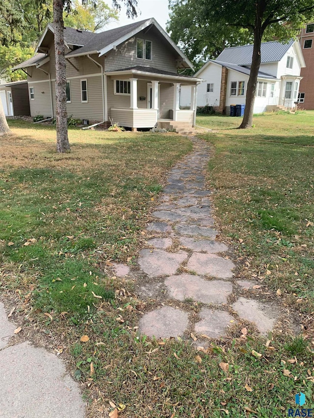 view of front of property with a porch and a front lawn