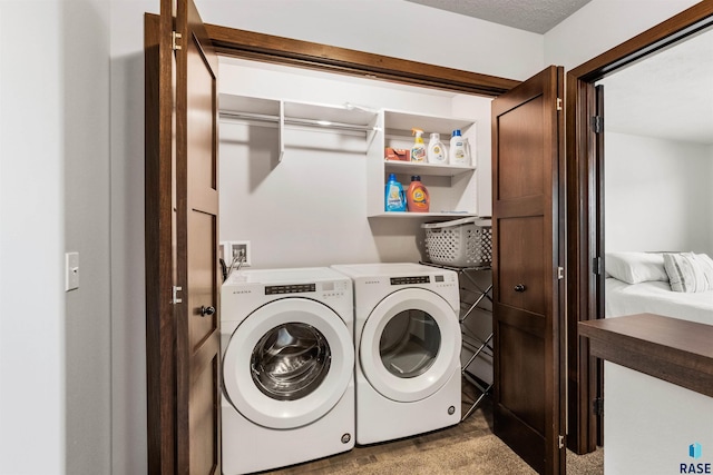 laundry room featuring washer and clothes dryer and light carpet