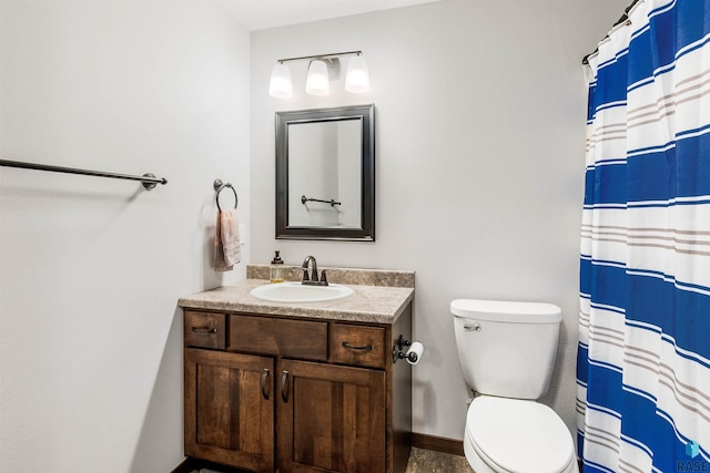 bathroom featuring vanity, toilet, and a shower with shower curtain