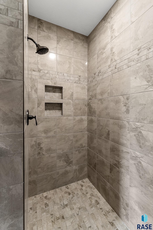 bathroom with a tile shower