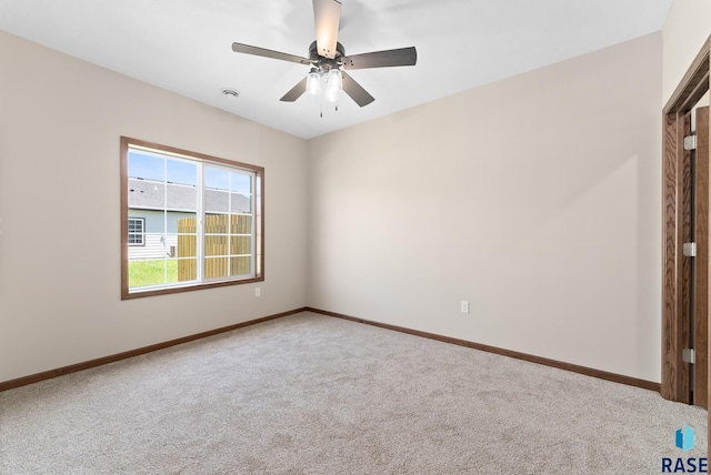 empty room with carpet flooring and ceiling fan