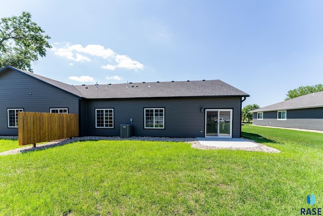 back of house featuring a lawn and a patio area