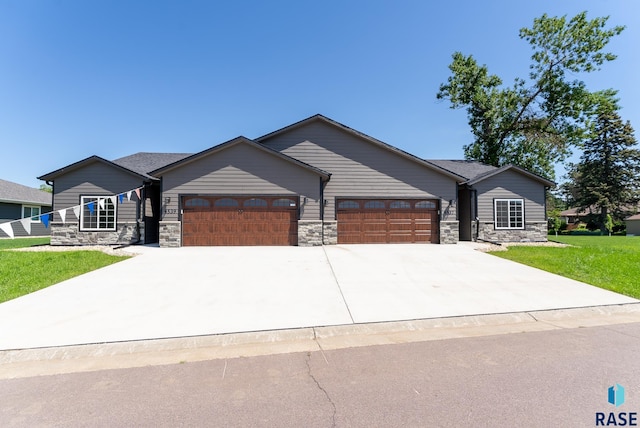 view of front of home with a garage and a front lawn