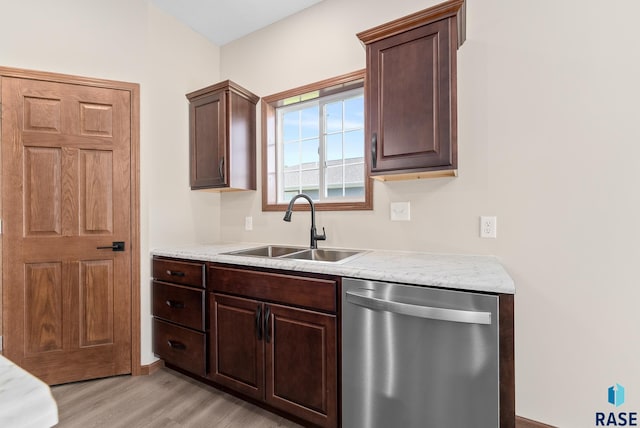 kitchen with dark brown cabinets, dishwasher, light hardwood / wood-style floors, and sink