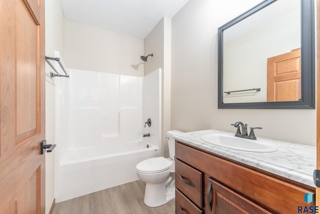 full bathroom featuring tub / shower combination, vanity, hardwood / wood-style floors, and toilet