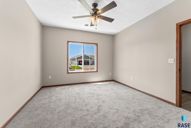 empty room featuring ceiling fan and carpet flooring