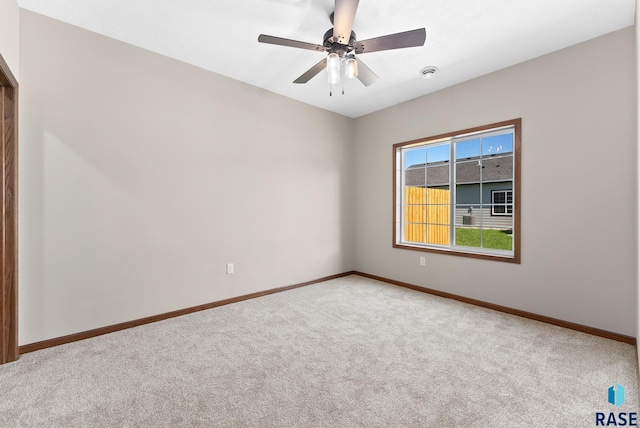 empty room with ceiling fan and carpet