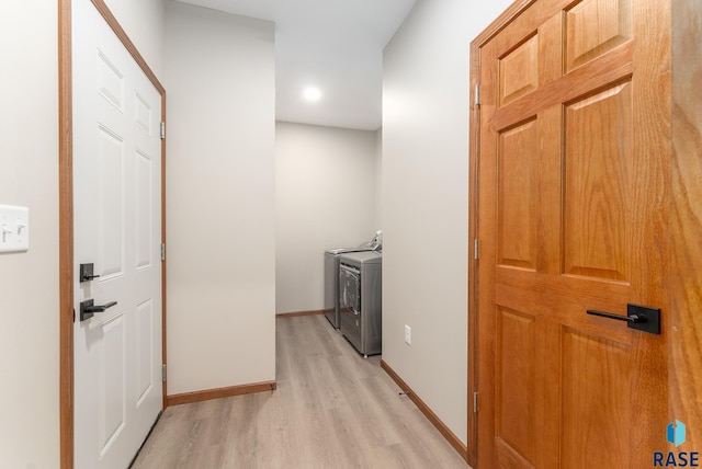 hallway featuring light hardwood / wood-style floors and washing machine and dryer