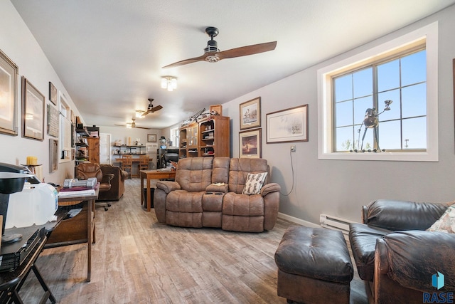 living room featuring baseboard heating, hardwood / wood-style floors, and ceiling fan