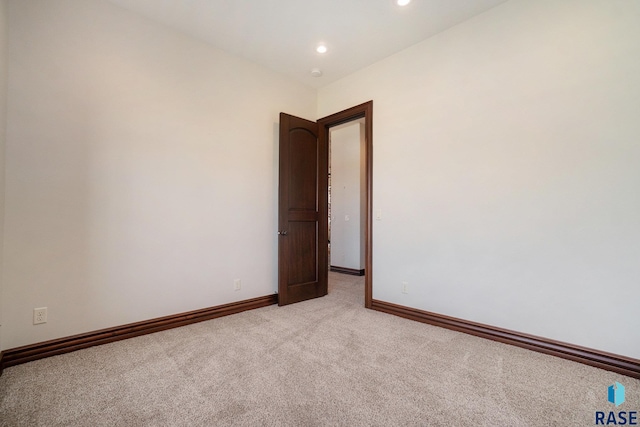 spare room with light carpet