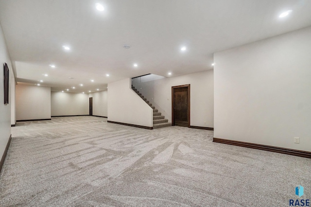 basement featuring light carpet