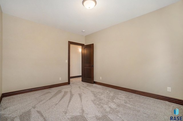 unfurnished room with light colored carpet