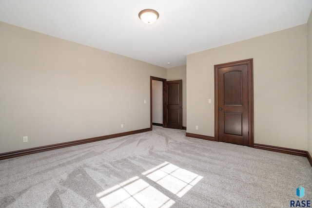 unfurnished bedroom featuring light carpet