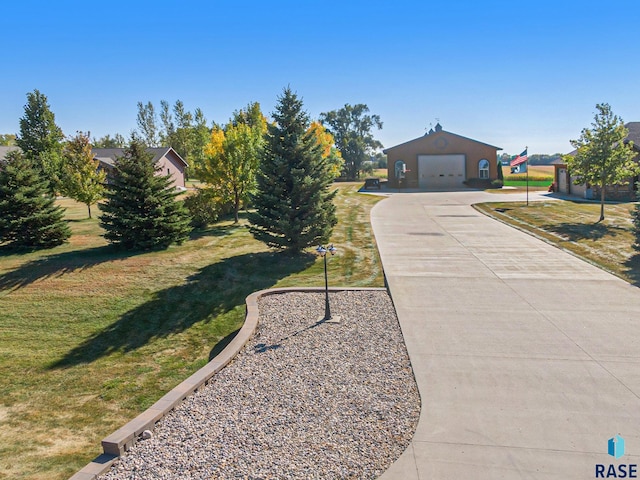 view of front of property featuring a garage and a front lawn