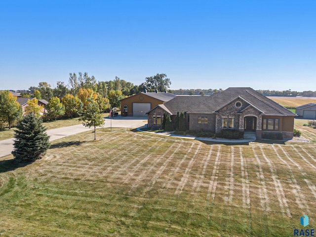 view of front of home with a garage and a front lawn