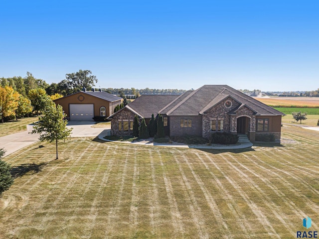 single story home with a garage, a rural view, and a front yard