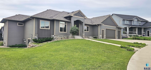 view of front of property with a garage and a front lawn