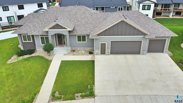 view of front facade with a garage and a front lawn