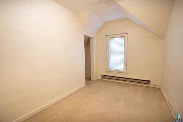 additional living space with light colored carpet, a baseboard radiator, vaulted ceiling, and a textured ceiling