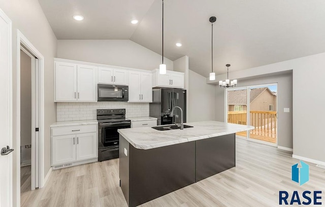 kitchen with black appliances, hanging light fixtures, decorative backsplash, an island with sink, and white cabinetry