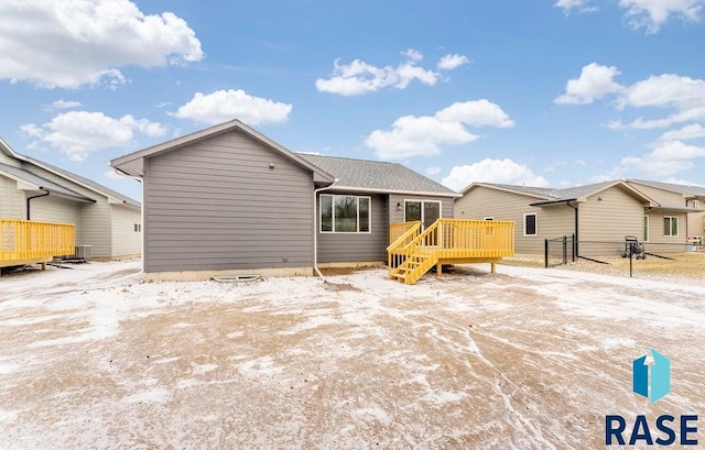 rear view of property featuring central air condition unit and a wooden deck