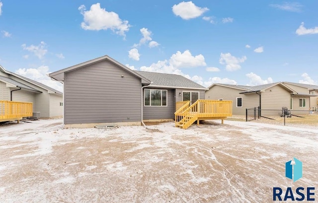 back of house with a wooden deck and central AC