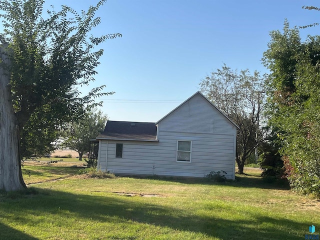 view of side of home with a lawn