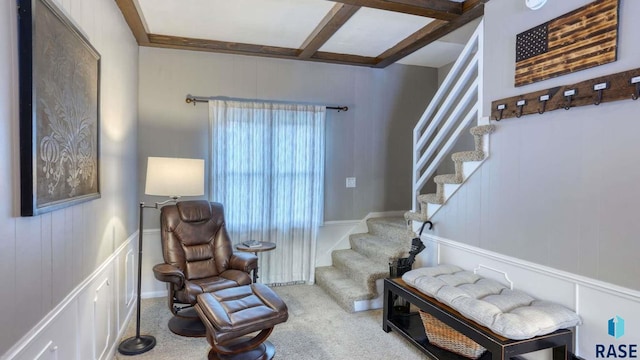 sitting room with coffered ceiling, beam ceiling, and carpet