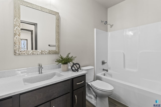 full bath with wood finished floors, vanity, shower / tub combination, and toilet