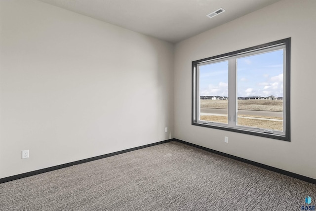 carpeted empty room with baseboards and visible vents
