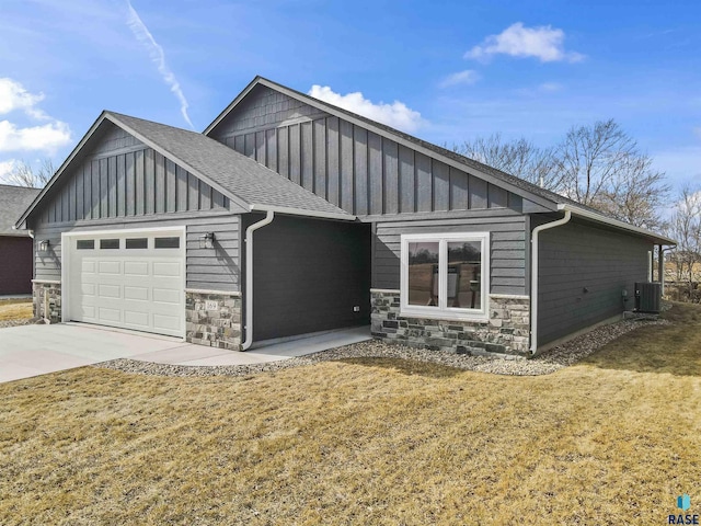view of front of property with board and batten siding, stone siding, and a garage
