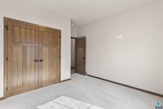 bedroom with a closet, carpet, and baseboards