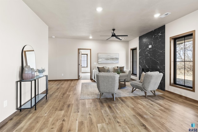 living room featuring recessed lighting, visible vents, ceiling fan, and light wood-style flooring