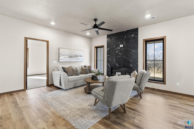 living room with recessed lighting, visible vents, ceiling fan, wood finished floors, and baseboards