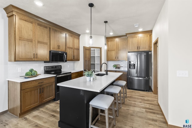 kitchen featuring black electric range oven, a sink, light wood finished floors, and stainless steel fridge with ice dispenser