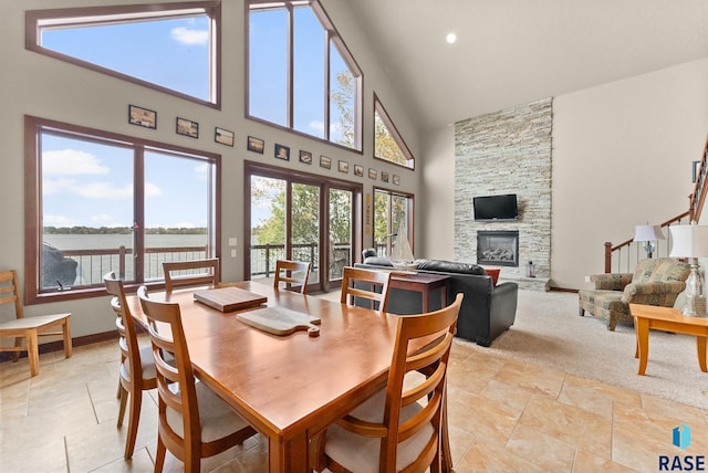 dining area with a wealth of natural light and high vaulted ceiling