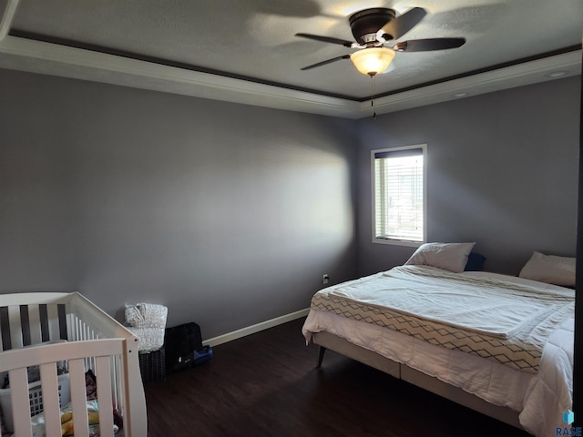 bedroom featuring ceiling fan and dark hardwood / wood-style floors