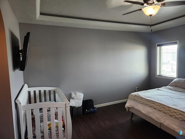 bedroom featuring ceiling fan and dark wood-type flooring